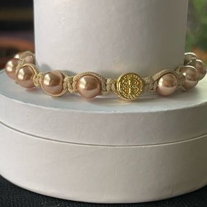 Beige rope and gold pearl bracelet.